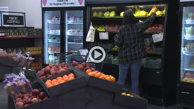 A woman is shopping at the grocery store.